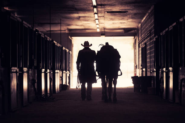 istock Cowboy at a horse stable 1198335021
