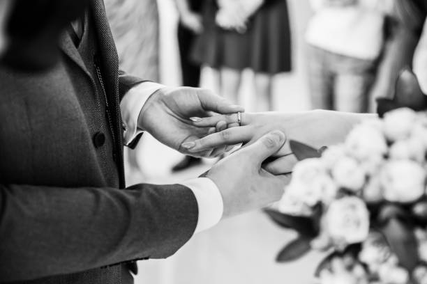 istock close up. bride and groom exchanging their wedding rings. 1198335039
