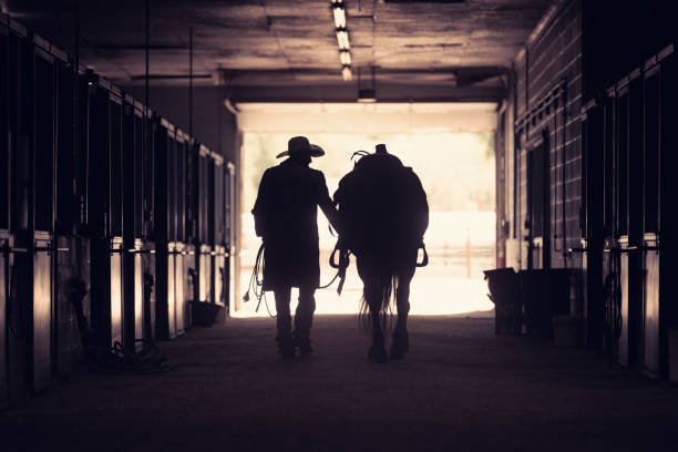 istock Cowboy at a horse stable 1198335078