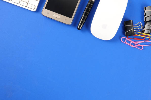 istock Top view of office staioneries over blue background. 1198335280
