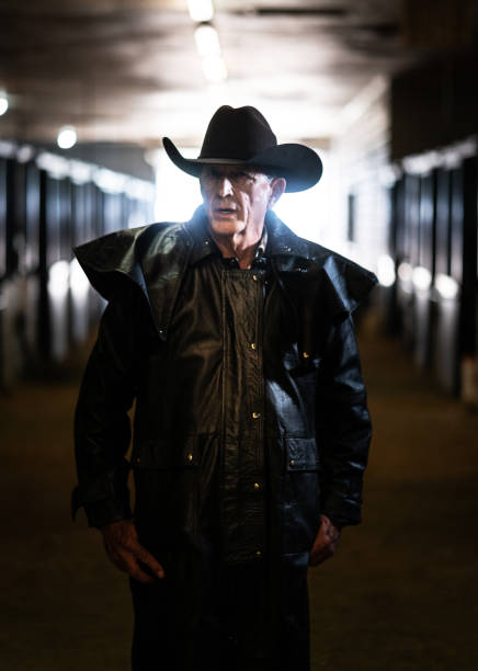 istock Senior cowboy at a horse stable 1198337131