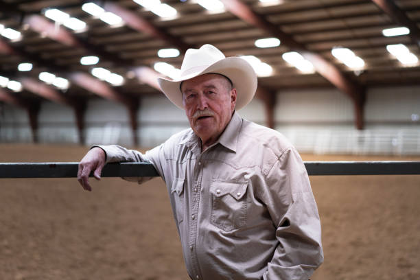 istock Senior cowboy at a horse stable 1198337957