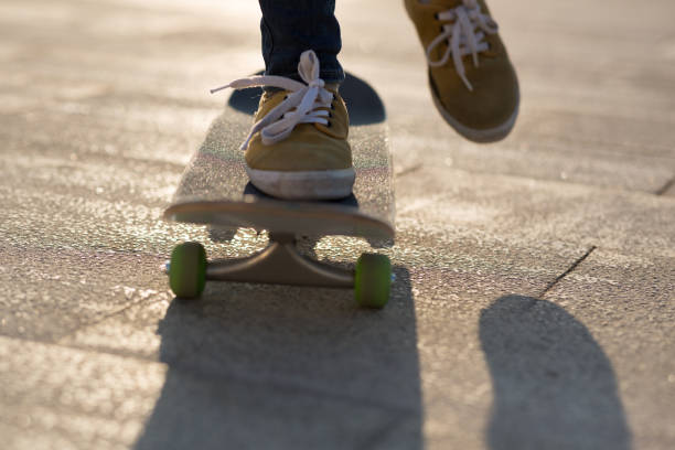istock Skateboarder legs skateboarding at city 1198338274