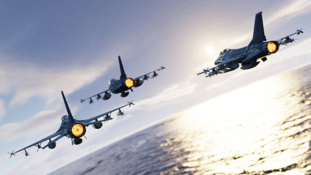 F-16 jet fighters flying together above the sea back view 3d render stock photo