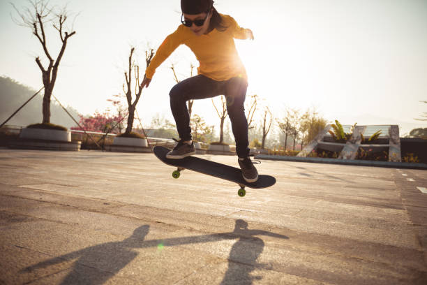 istock Skateboarder skateboarding at sunrise park 1198339414