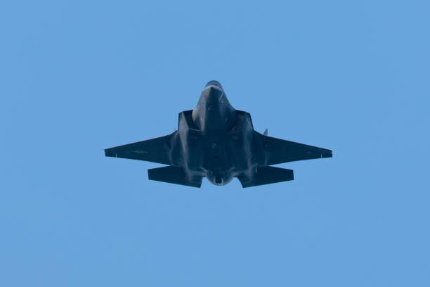 istock Bottom view of a Combat aircraft  approaching in beautiful light 1198340191