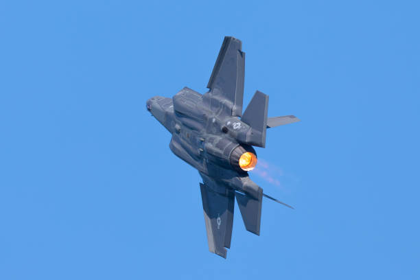 istock Combat aircraft in a turn with afterburner on 1198340200