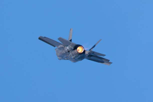 istock Combat aircraft in a turn with afterburner on 1198340213