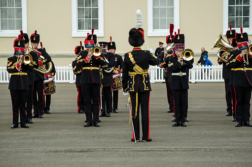 Sandhurst, Berkshire, UK - June 16, 2019: Conductor directing musicians of the Royal Artillery Band at a public performance at the famous Sandhurst Military Academy on a sunny summer day in Berkshire.
