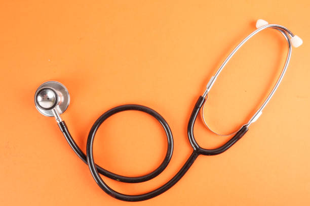 istock Medical Concept with stethoscope ,syringe  isolated on orange background. Copy Space 1198341631