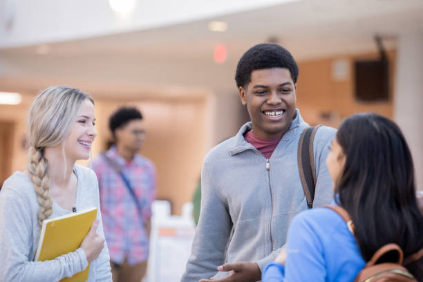 istock Group of college friends discussing assignment 1198346510
