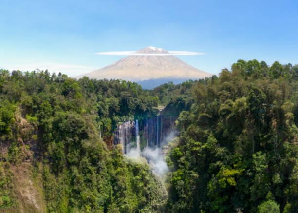 Waterfall, volcano and tropical rainforest in Indonesia