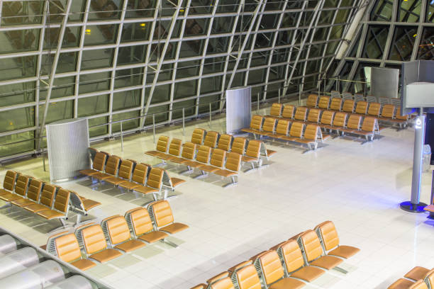 istock The empty airport terminal waiting area with chairs in night 1198348532