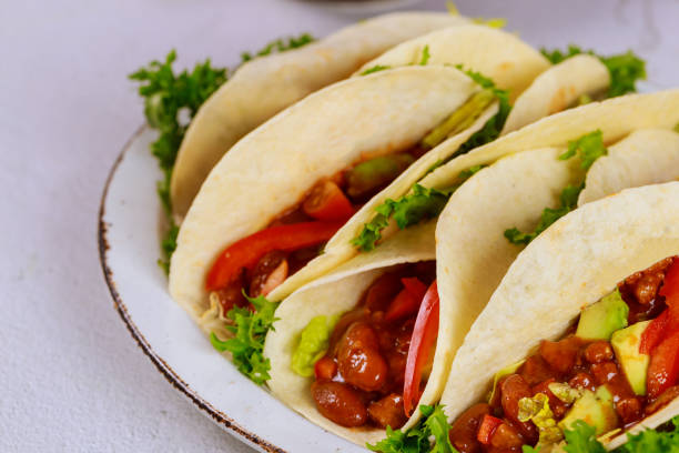 istock Soft tortillas stuffed with beans, beef and vegetable. Close up. 1198349131