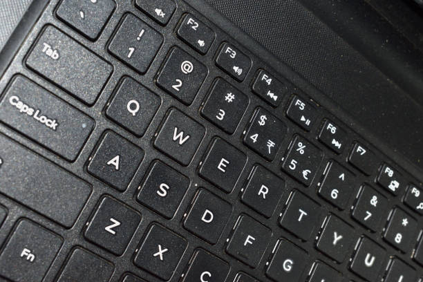 istock Side photo of a laptop keyboard showing brushed black surface. Technology concept. selective focus. 1198349140
