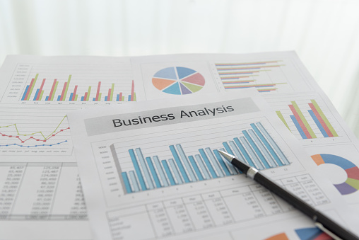 Business analysis report, Financial graph and chart summary report on desk.