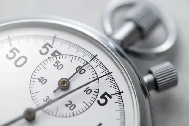 Classic metallic chrome mechanical analog stopwatch. Close up shot.