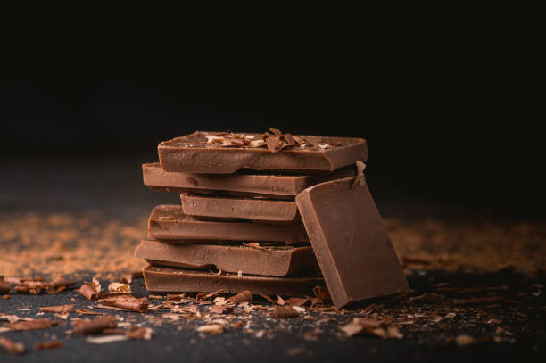 Milk chocolate stack Milk chocolate stack on dark background milk chocolate stock pictures, royalty-free photos & images