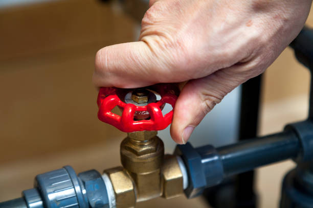 istock Hand spins valve close-up 1198359856