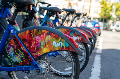 San Francisco, CA OCTOBER 5, 2019: Row of Lyft Bikes sitting at bikeshare docking station in parking lot on street