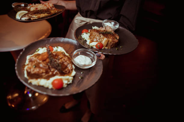 istock the waiter is holding a beef steak with mashed potatoes 1198361046
