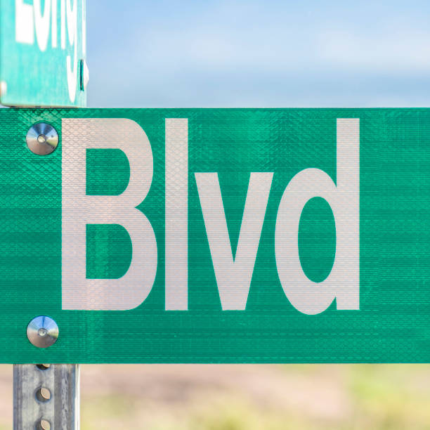 istock Square frame Selective focus on a green and white road street sign that reads Blvd 1198362532