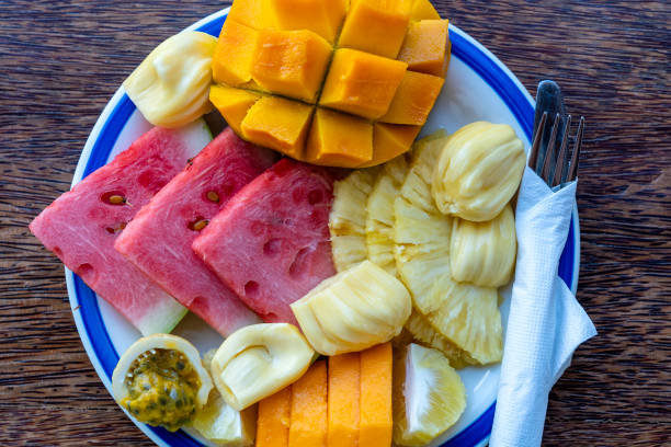 istock Tropical fruits on a breakfast plate, close up, top view 1198363519