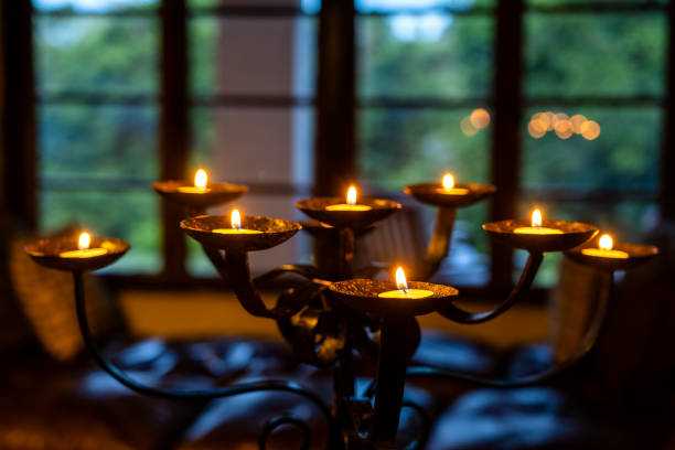 The flaming candles on a candlestick in evening. Close up