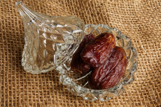 istock Date in a glass container on a rug background. 1198366934