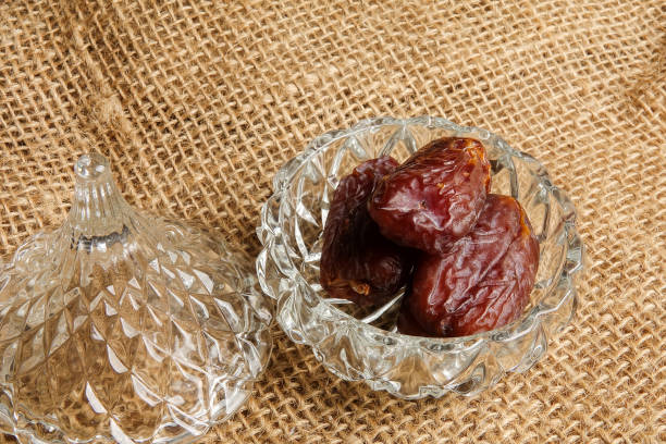 istock Date in a glass container on a rug background. 1198366937
