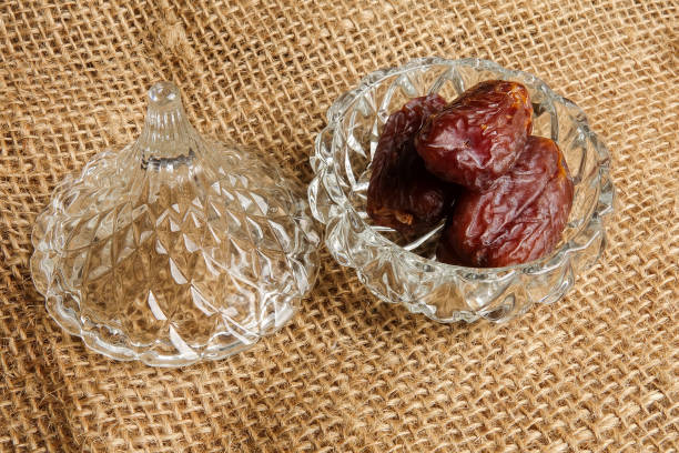 istock Date in a glass container on a rug background. 1198366940