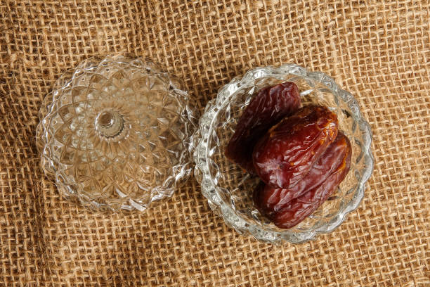 istock Date in a glass container on a rug background. 1198366942