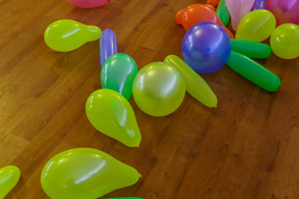 istock Multicolored inflatable balloons scattered on the floor. 1198367431