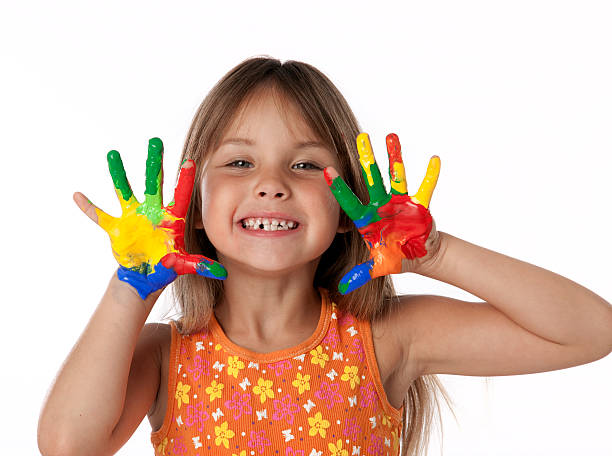 Cute Girl With Finger Paint Hands stock photo