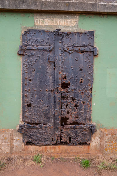 istock Tall steel metal door labeled off limits eroded from rust and elements warning off limits 1198375402