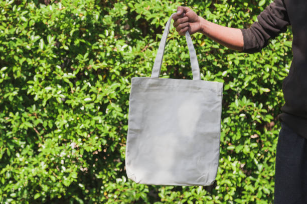 istock Man holding bag canvas fabric for mockup,ecology Concept. 1198375532