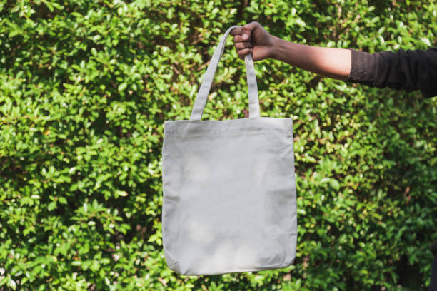 istock Man holding bag canvas fabric for mockup,ecology Concept. 1198375550
