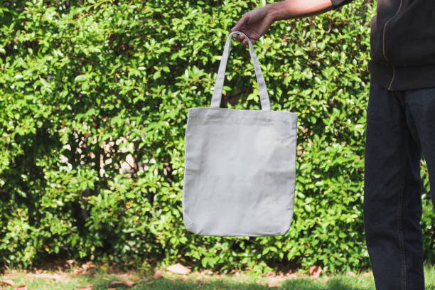 istock Man holding bag canvas fabric for mockup,ecology Concept. 1198375584