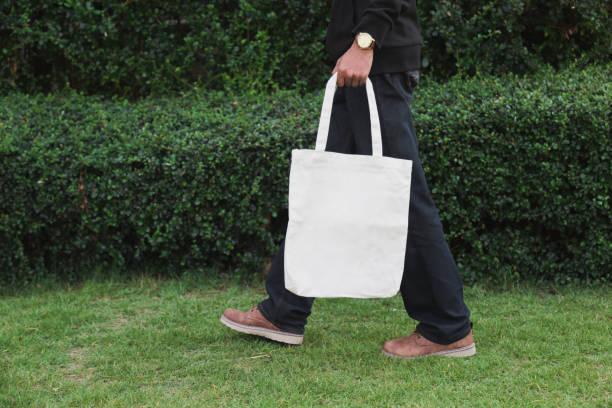 istock Man holding bag canvas fabric for mockup,ecology Concept. 1198375637