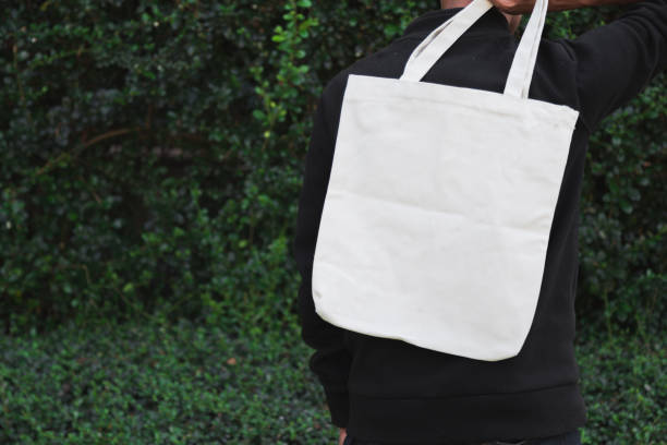 istock Man holding bag canvas fabric for mockup,ecology Concept. 1198375639
