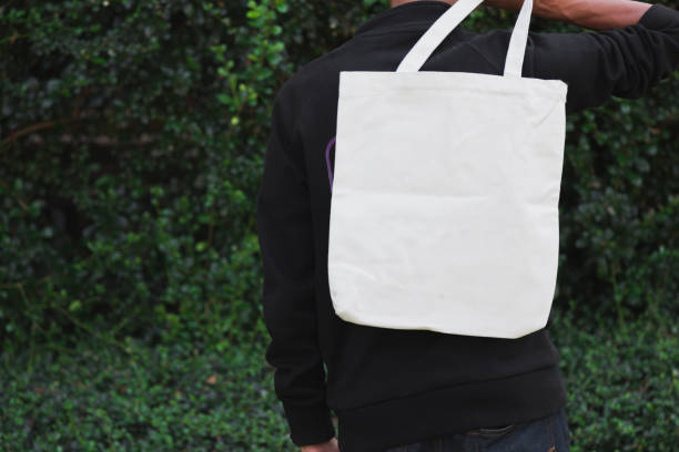 istock Man holding bag canvas fabric for mockup,ecology Concept. 1198375646