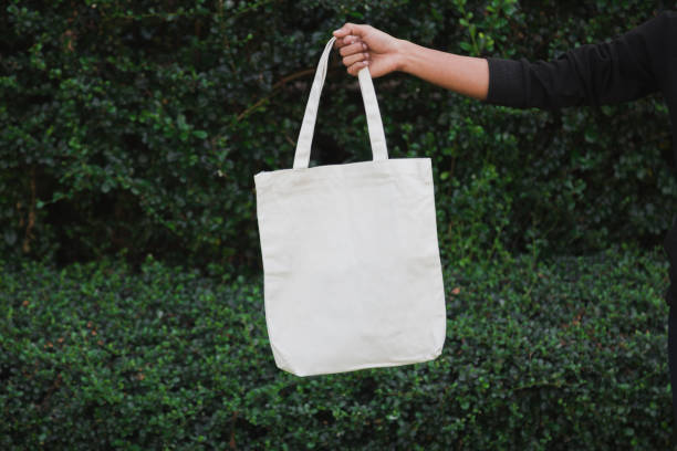 istock Man holding bag canvas fabric for mockup,ecology Concept. 1198375719