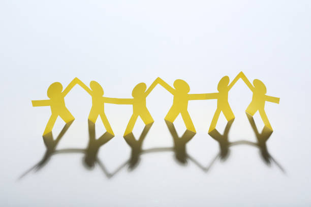 istock Paper chain people on white background 1198375956