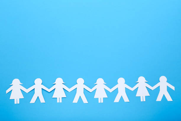 istock Paper chain people on yellow background 1198375988