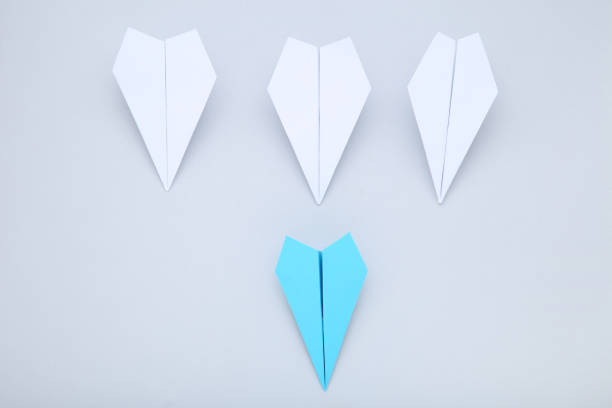 istock Paper plane leader on gray background 1198378547