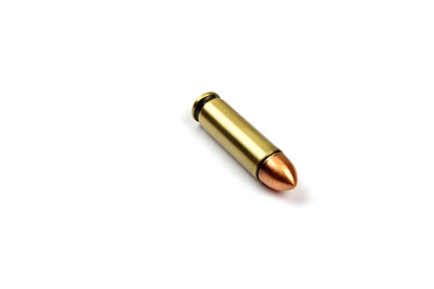 one shiny pistol bullet on a white background
