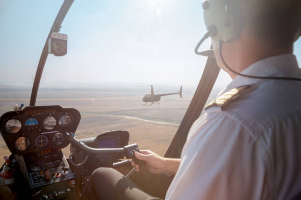 istock Pilot flying a helicopter above the plain area 1198387258