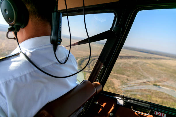 istock Flying a helicopter above plain region 1198387266