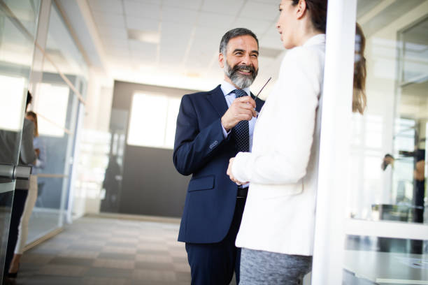 istock Business people having fun and chatting at workplace office 1198387354