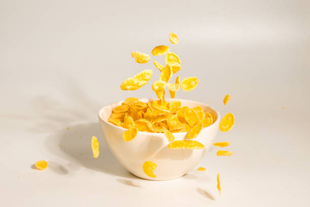 istock Corn flakes falling to the white bowl. Motion. 1198387762